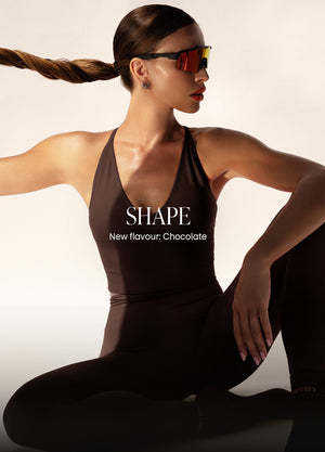 Model wearing chocolate Shape set activewear with sports bra and leggings